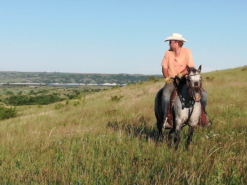 South Dakota rancher overlooks green pastures and the Missouri River.